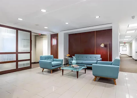 The lobby of an office building with blue furniture. Office Rental Spaces in Farragut West | 1725 I Street NW, 3rd Floor, Washington, DC 20006