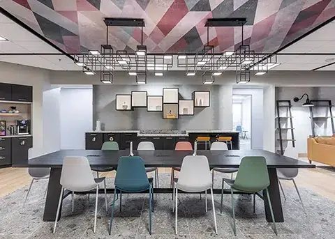 A conference room with colorful chairs and a colorful ceiling. Conference Room Rental In Reston | 11710 Plaza America Dr #2000, Reston, VA 20190